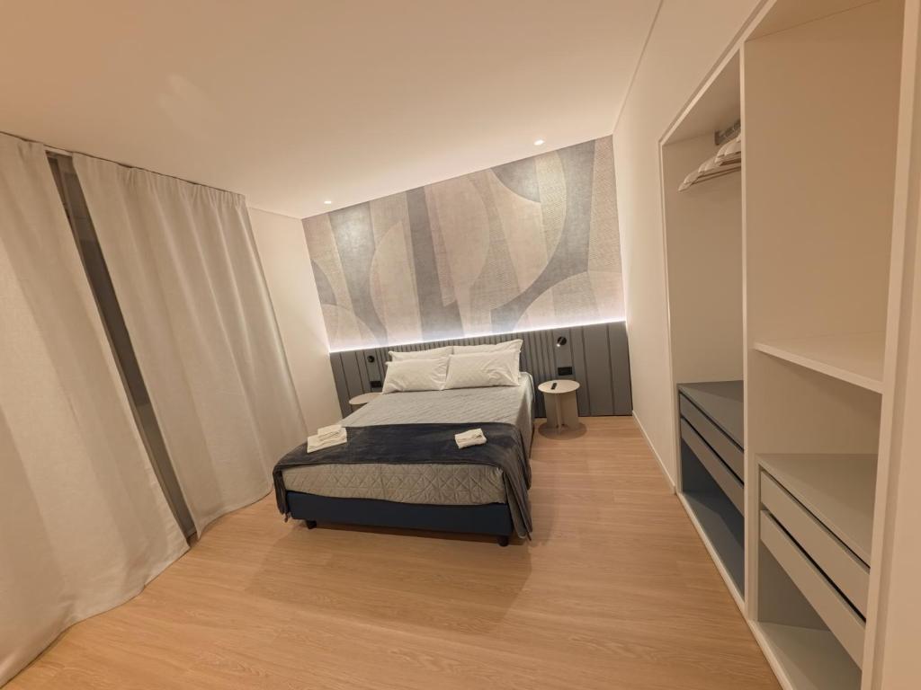 a small bedroom with a bed and a closet at Loft 26 Apartment in Caltanissetta
