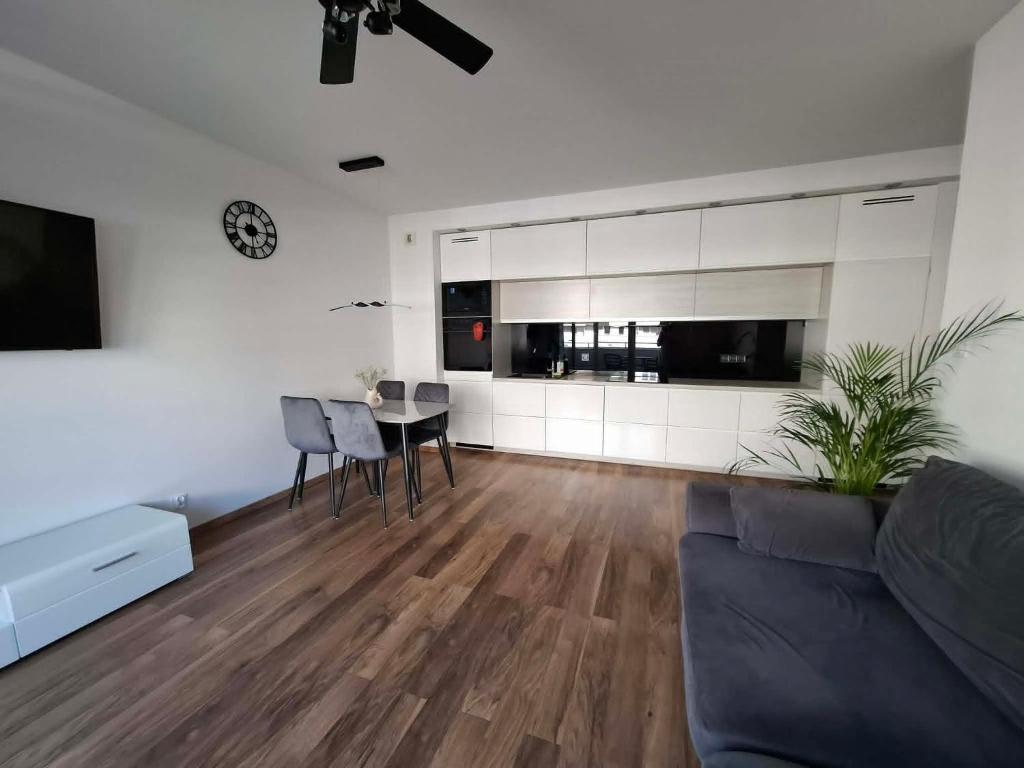 a living room with a couch and a table at Apartament Rekiny na Wakacjach - Aquapark Reda 200m - Prywatny Parking in Reda