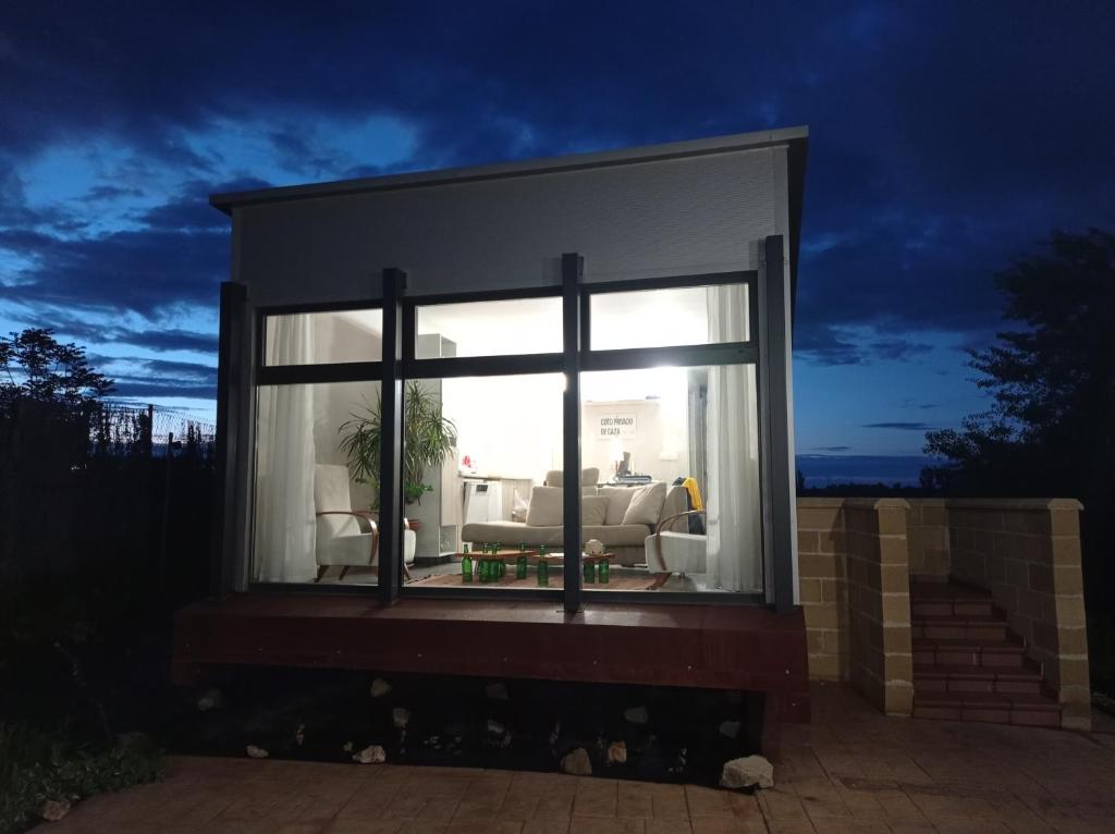 a large window of a house with a living room at solar eclipse house in Husillos