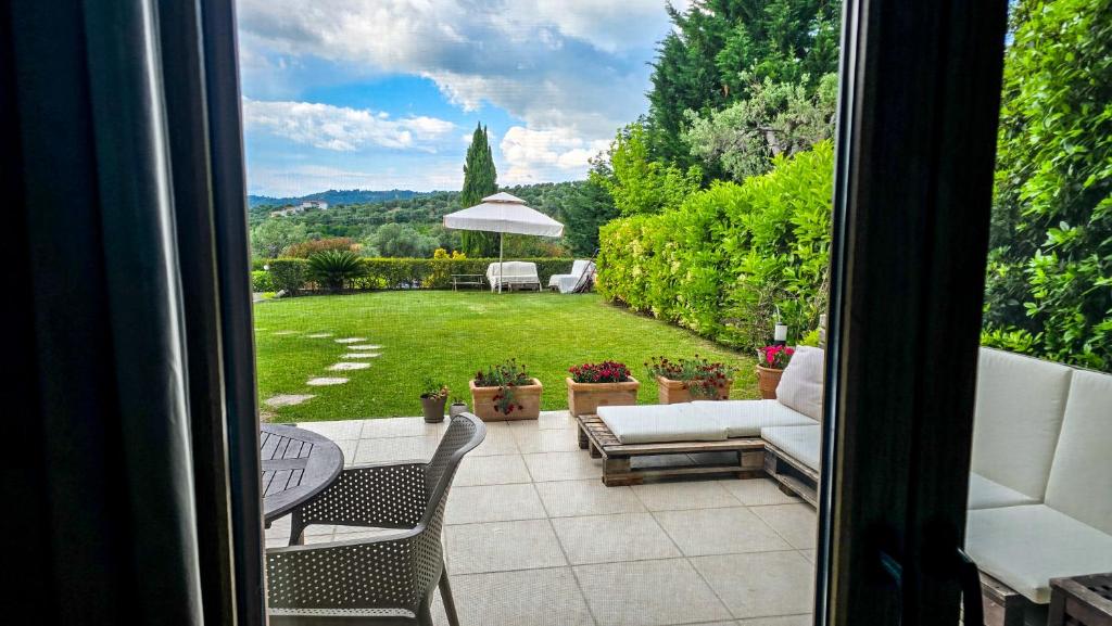 a view from a window of a patio with a yard at Angelo’s Elegant Summer House in Possidi