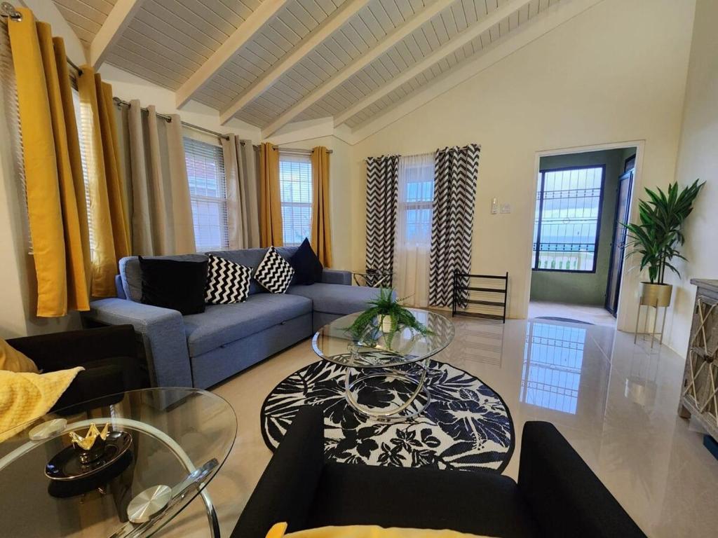 a living room with a couch and a table at Honeycomb Oceanview Villa in Falmouth