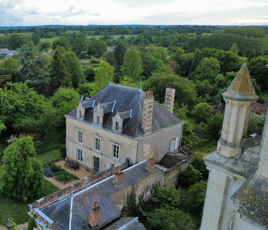 an aerial view of an old house with a tower at Fleurs et Abeilles in Faye-lʼAbbesse