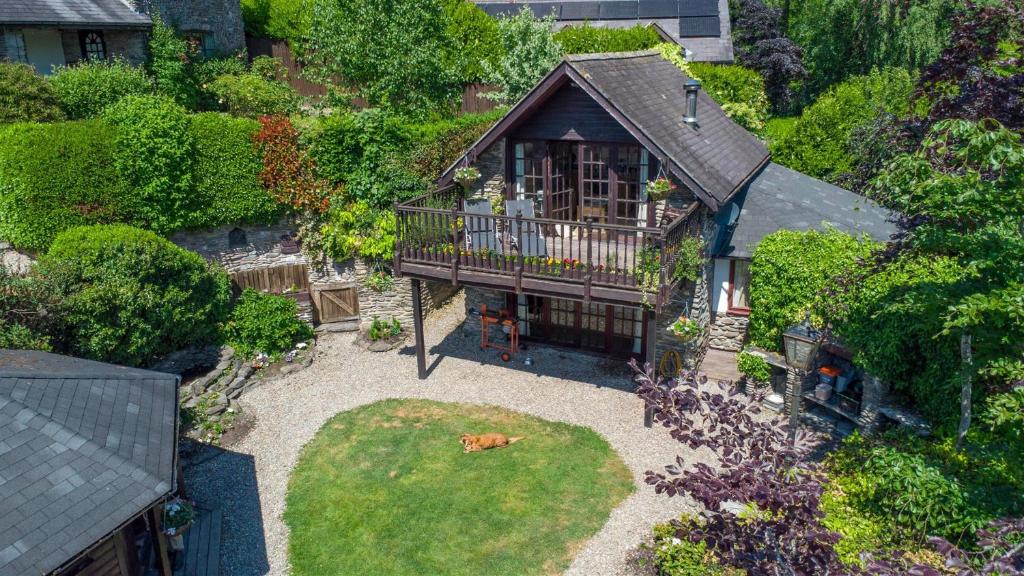 an aerial view of a house with a patio and a dog laying in the yard at Horseshoe Pass Holiday Lets in Llangollen