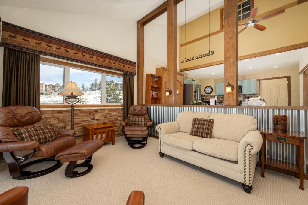 a living room with furniture and a large window at Mountainside Unit B-8 in Granby