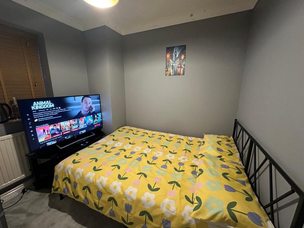 a bedroom with a bed and a flat screen tv at 40 kennett gardens in Gloucester