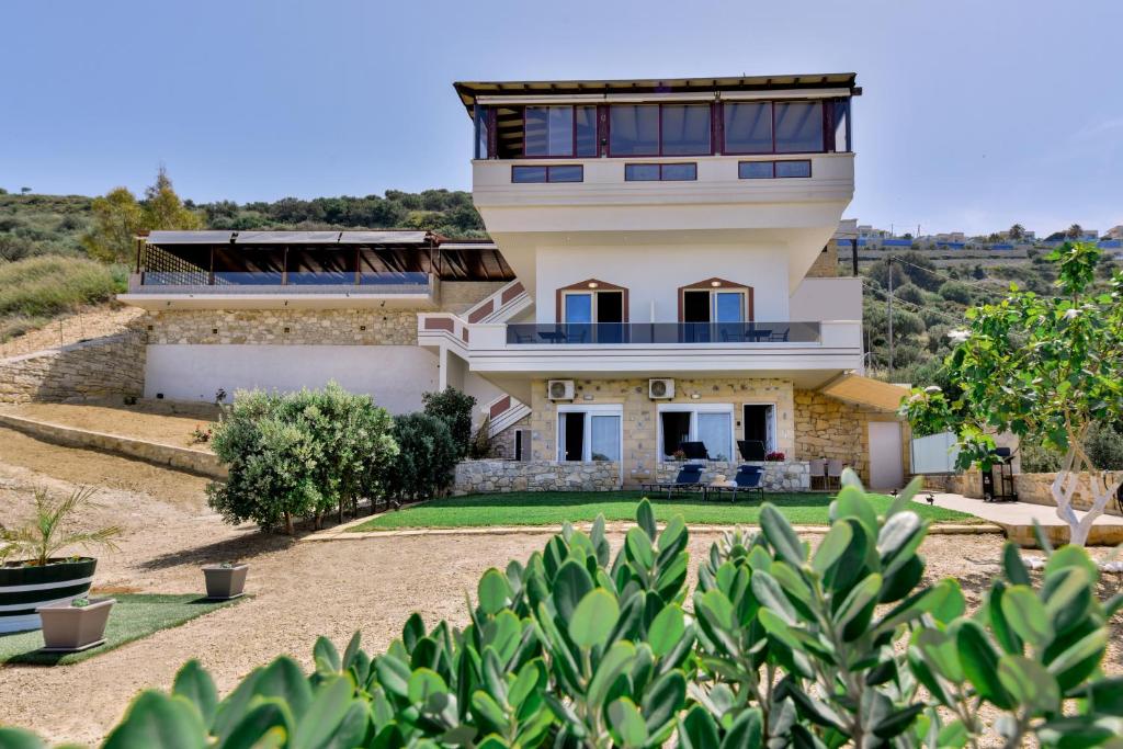 a house on a hill with a yard at Mathios Apartments Falassarna in Falasarna