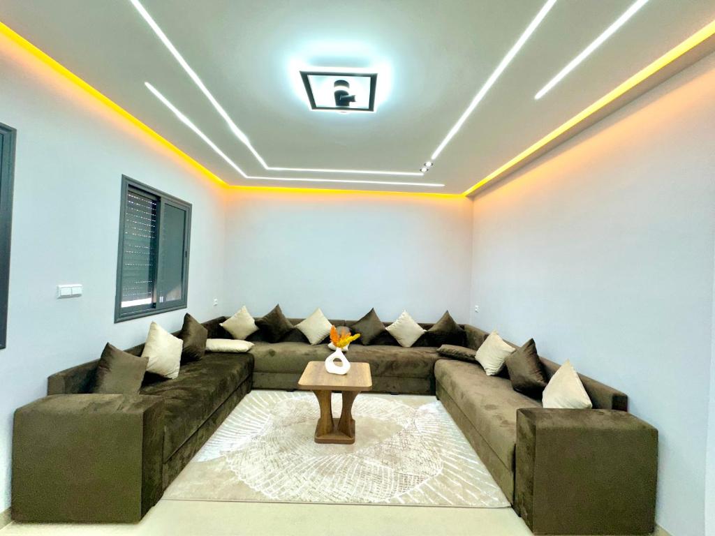 a living room with a couch and a table at Palm & Tide Kenitra Residence in Kenitra