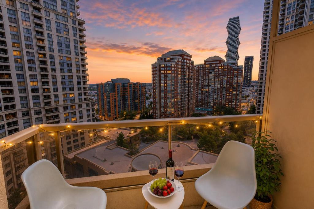 a balcony with a table and chairs and a view of a city at High-End 2BR 2BATH Condo-Steps to Square One Mall in Mississauga