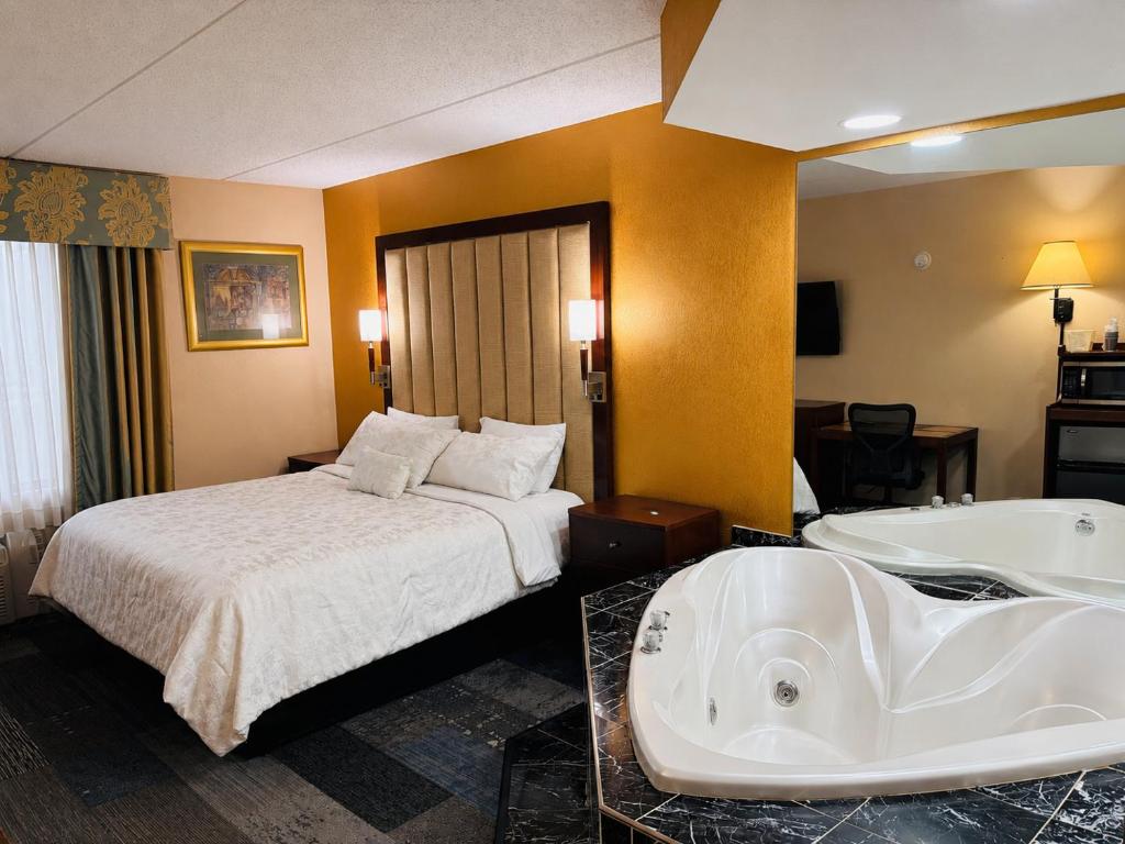 a hotel room with a bed and a bath tub at Hotel M Mount Pocono in Mount Pocono