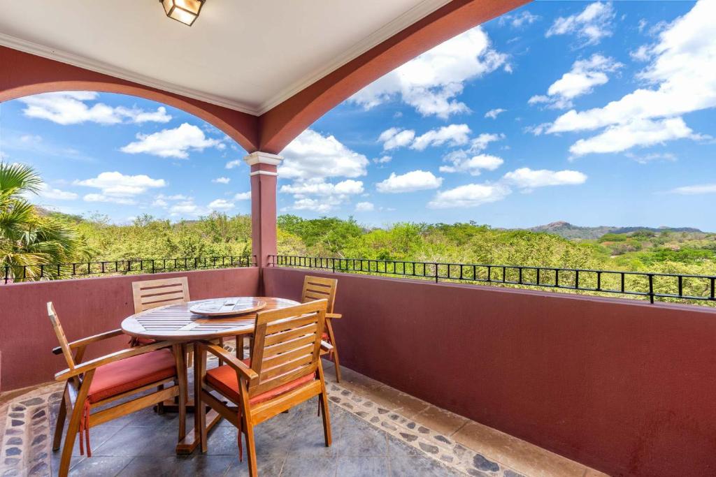 a patio with a table and chairs on a balcony at Recently Renovated Luxury Condo with Resort-Style Beach Club Access and Ocean Views in Playa Conchal