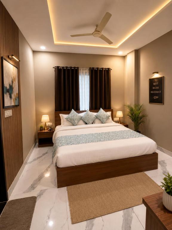 a bedroom with a large bed and a window at Hotel Golden Glory Scheme 103 in Indore