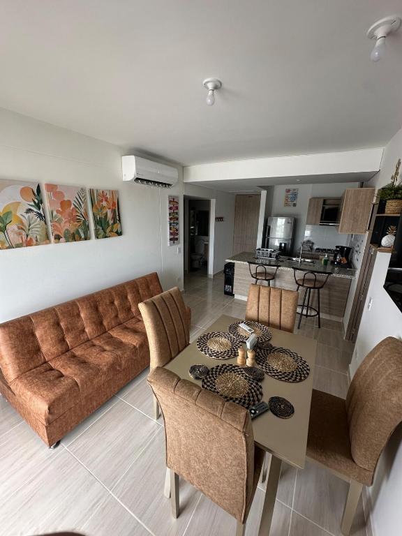a living room with a couch and a table at Loft Apartment - Full AC With Free Parking Pool in Cartagena de Indias