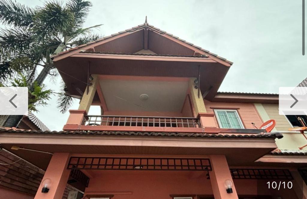 a house with a balcony on top of it at Aonang Poonsiri Cozy Villa in Ban Khlong Haeng