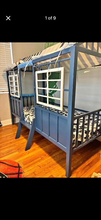 a blue bunk bed with a window in a room at Pixie hollow single vacation retreat resort space in Orlando