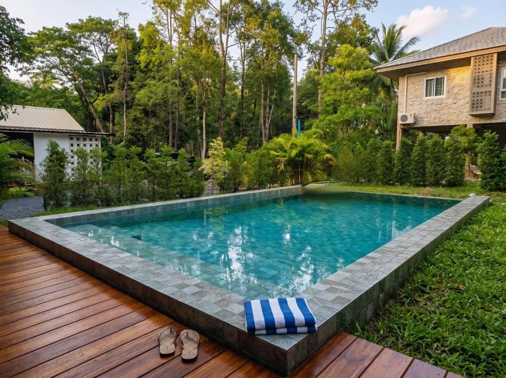 a swimming pool with a deck and a house at Villa Vista in Wok Tum