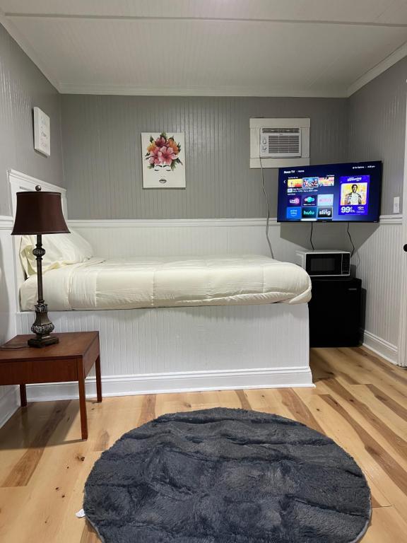 a room with a bed and a tv on a wall at Brooklyn's Tiny Apartment Pets Welcome in North Little Rock