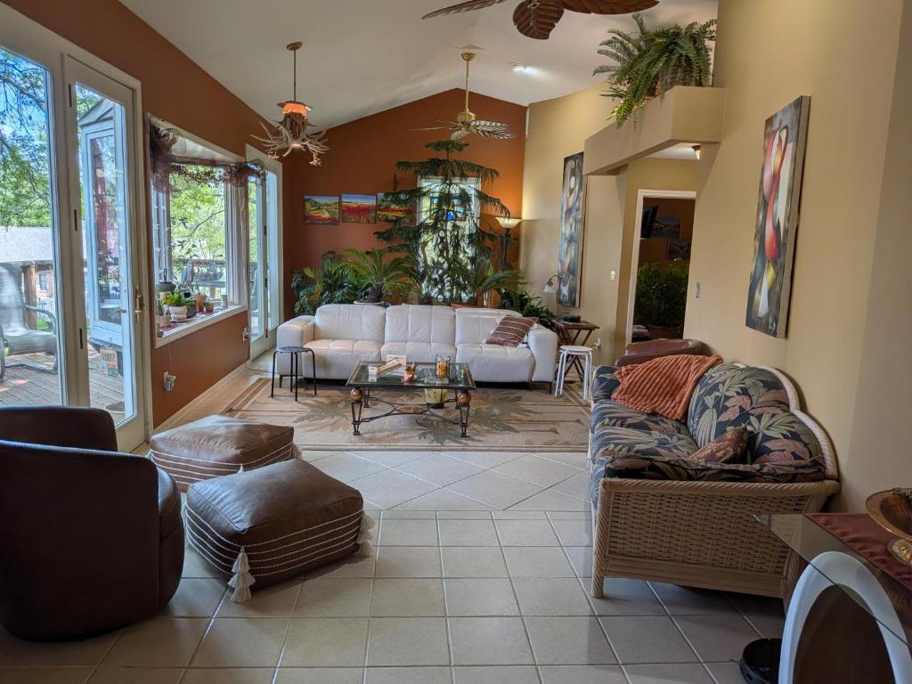 a living room with white couches and a table at FIFA Basecamp with 2 Kitchens, 5BR, 4 Baths in Roeland Park