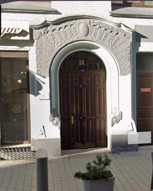 an entrance to a building with a large wooden door at City Centre Cozy Guesthouse in Riga