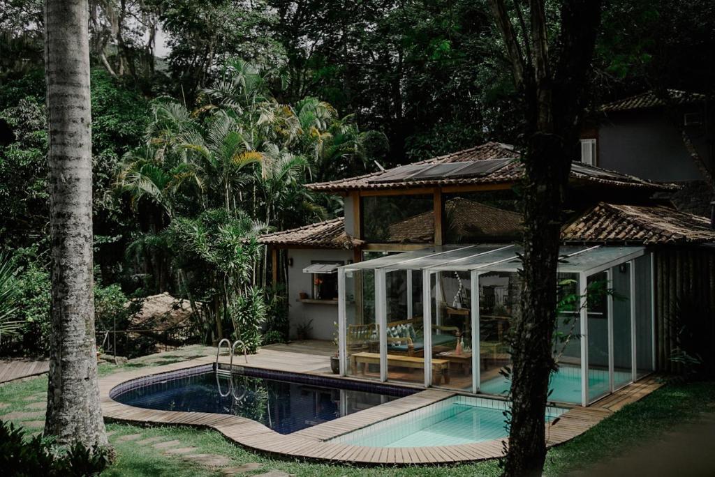 a house with a pool in front of it at Villa Don in Petrópolis