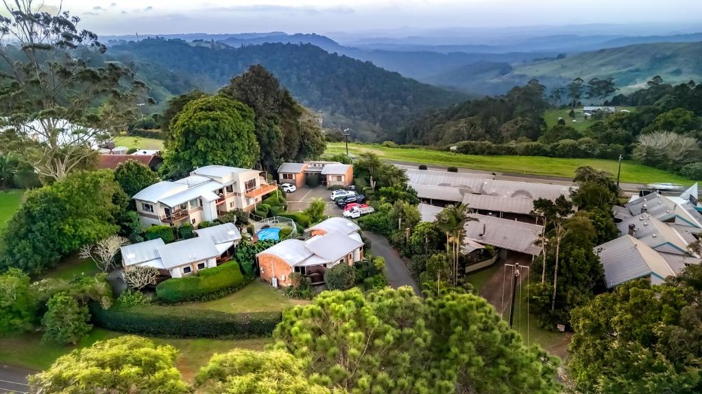 an aerial view of a house with a road and trees at Maleny Terrace Cottages in Maleny