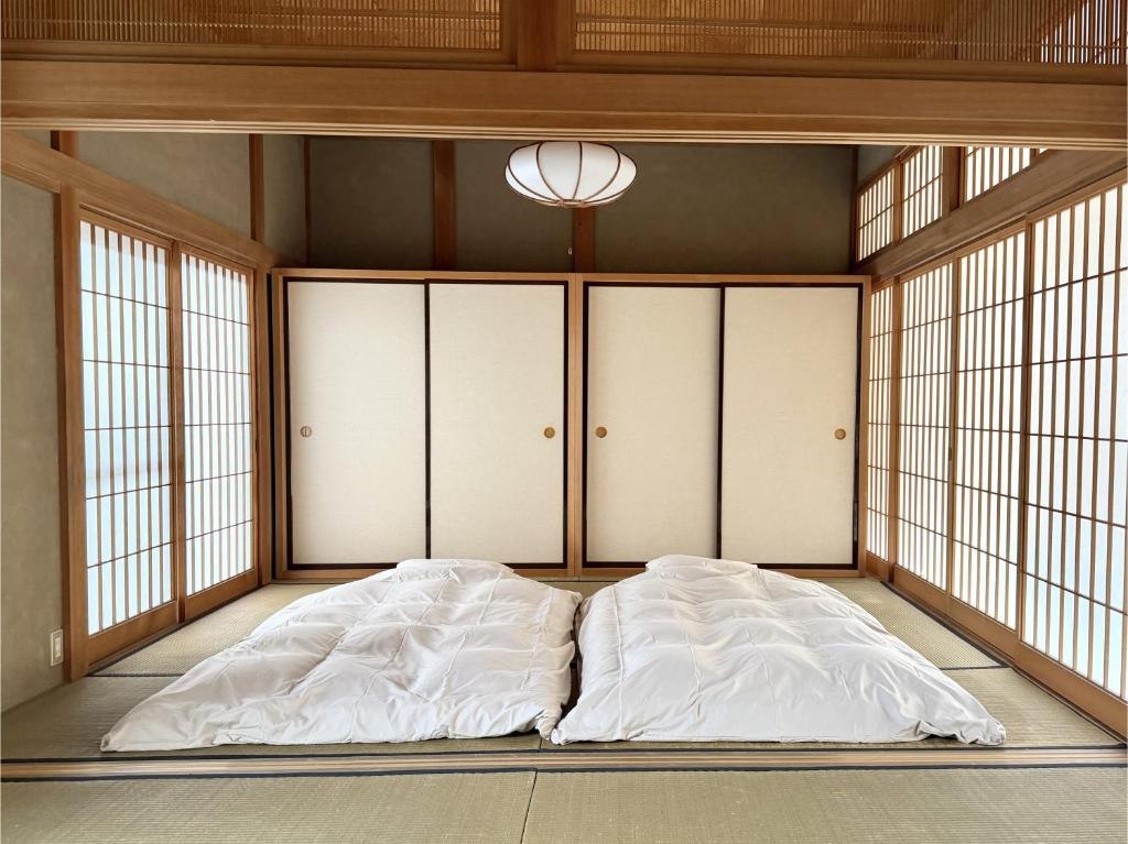 a large bed in a room with windows at ccb hotel 90Minutes from Tokyo in Chichibu