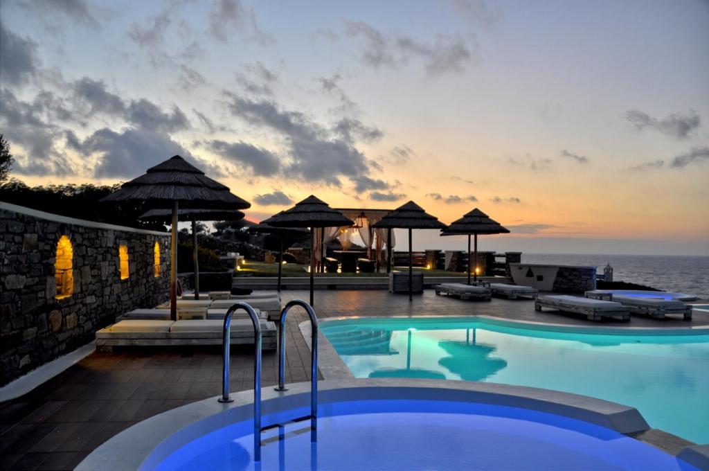 a swimming pool with a view of the ocean at Toxotis Villas in Armenistis