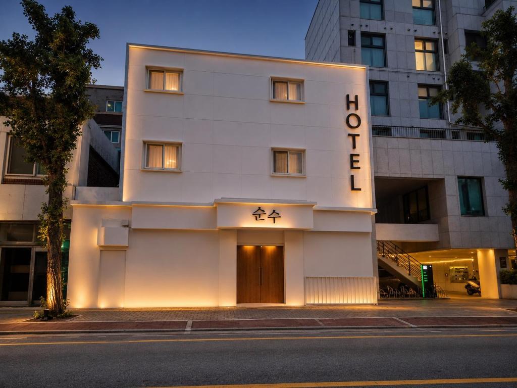 a white building with a sign that reads hotel at Hotel Soonsu Mia in Seoul