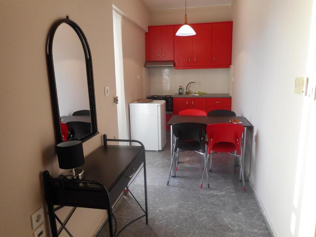 a kitchen with a table and chairs and a mirror at ComeHome in Heraklio Town