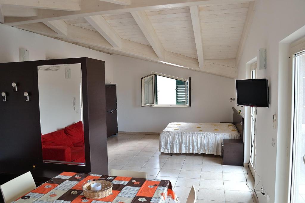 a bedroom with a bed and a tv in a room at Appartamenti In Residence Zoe in Roseto degli Abruzzi