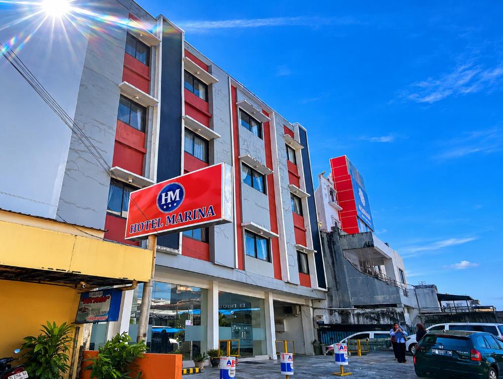 a building with a sign in front of it at Marina Jampea Hotel in Makassar