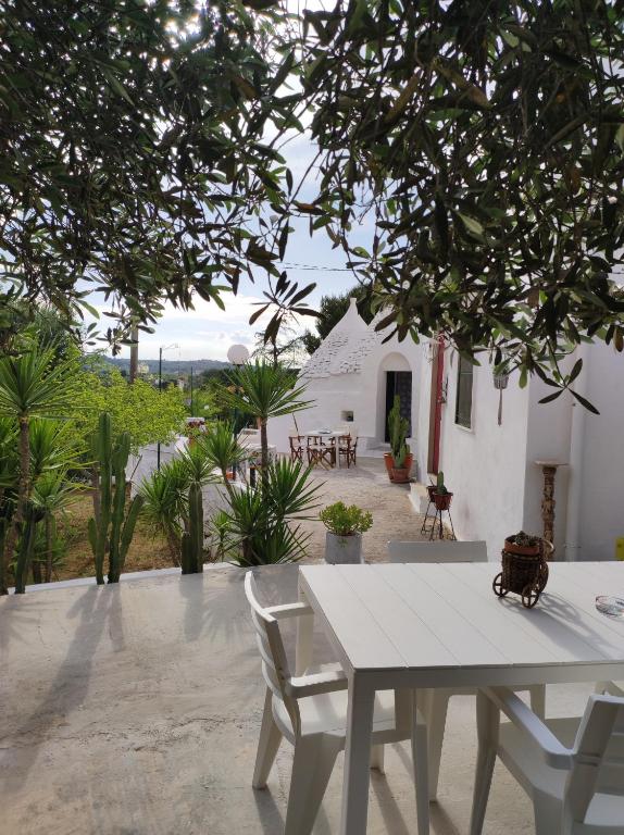 a white table and chairs on a patio at Trullo Nunuccio in Ceglie Messapica