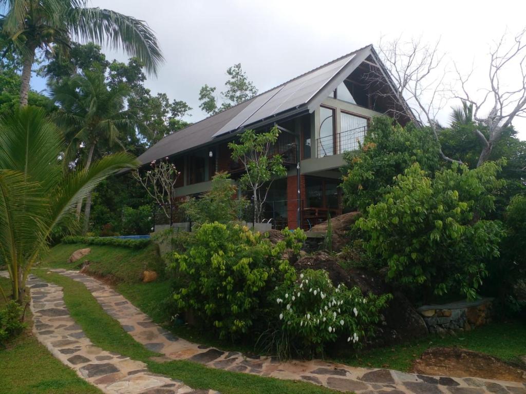 a house with a walkway in front of it at Moonstone herbal villa in Balapitiya