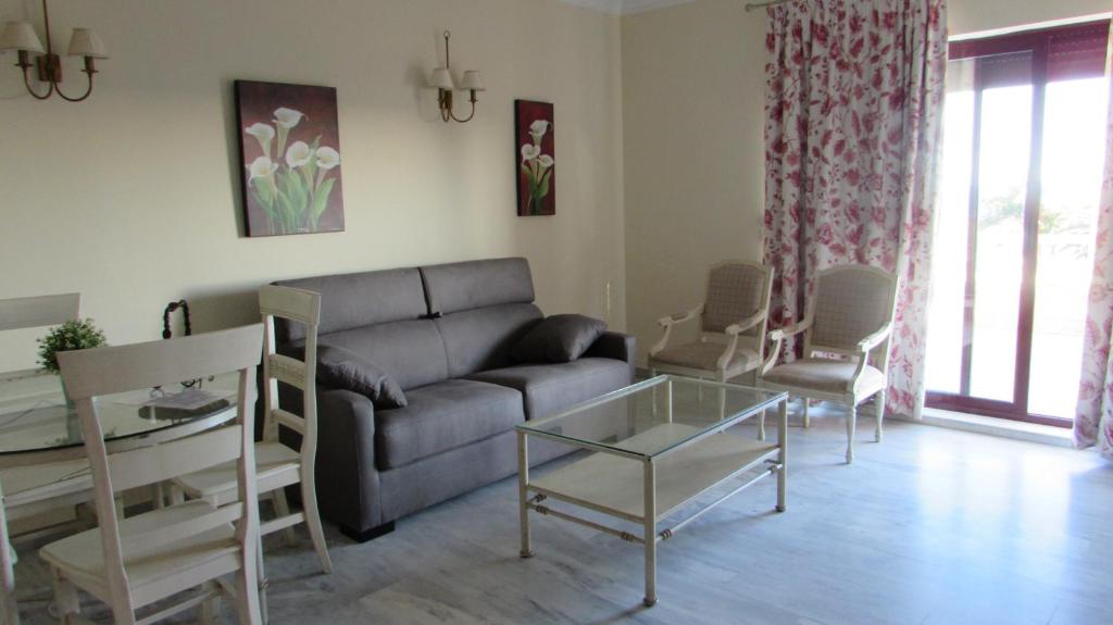 a living room with a couch and a glass table at Home4Holidays in Nerja