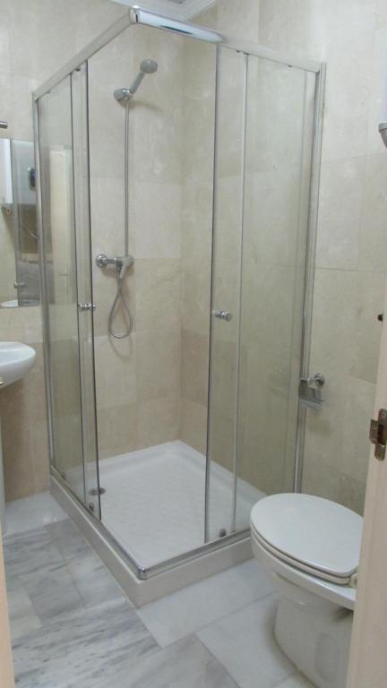 a bathroom with a shower with a toilet and a sink at Home4Holidays in Nerja