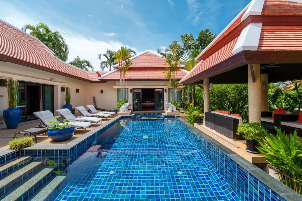a swimming pool in the backyard of a villa at The Baan Bua Elefant Villa in Rawai Beach
