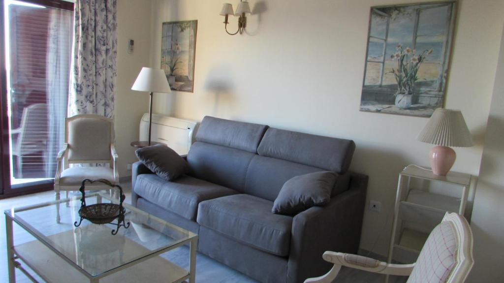 a living room with a couch and a glass table at Home4Holidays in Nerja