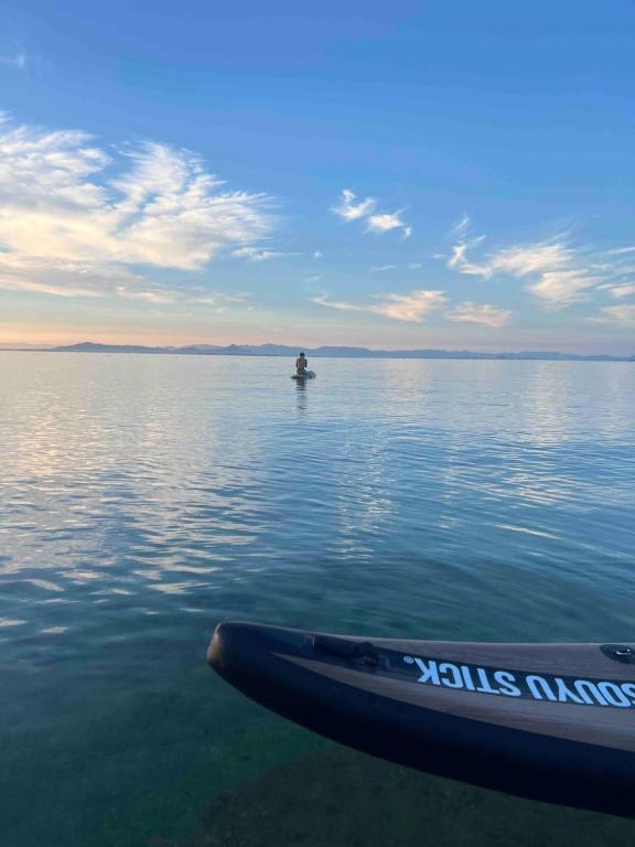 a person in a boat on a large body of water at fully in Otsu