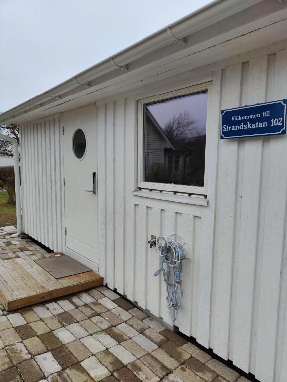 a garage with a window and a sign on it at Strandskatan 102 in Halmstad