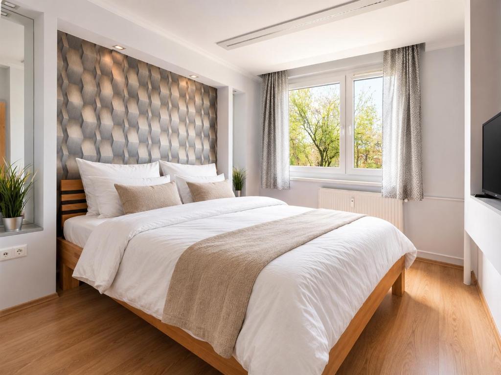 a white bedroom with a large bed and a window at Comfort 66 Large Family City Home in Miskolc