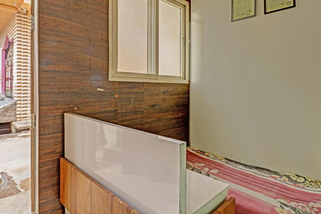 a kitchen with a white counter and a wall at SPOT ON HOTEL MOONLIGHT in Bhilai