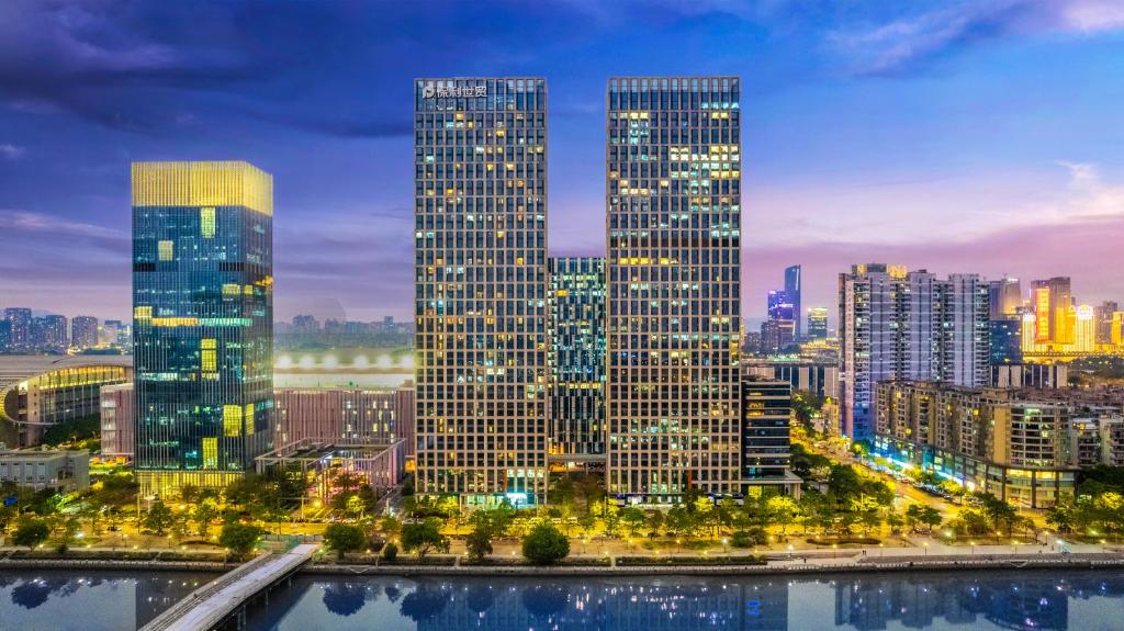 a city skyline with tall skyscrapers at night at HeeFun Apartment GZ -Poly World Trading Center in Guangzhou