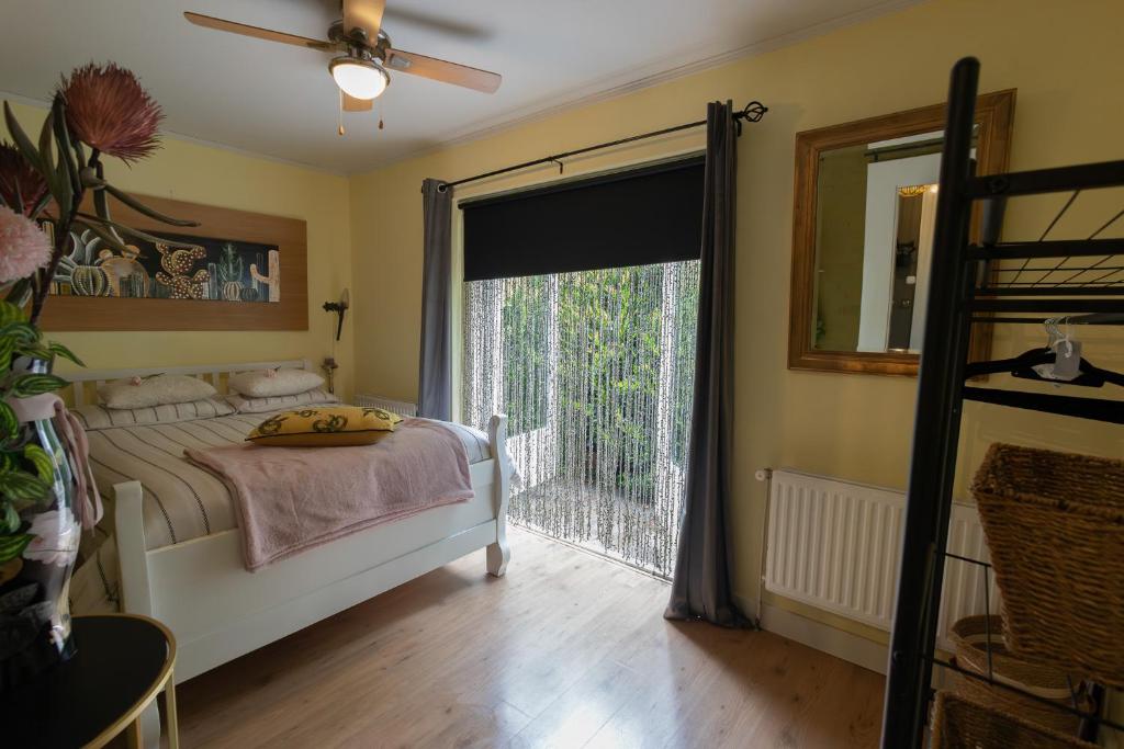 a bedroom with a bed and a large window at Studio Unique in Enschede