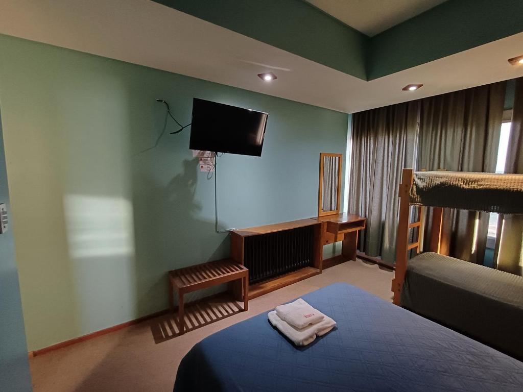 a bedroom with a bed and a flat screen tv at Hotel cirse cr in Comodoro Rivadavia