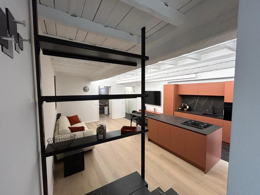 a loft apartment with a loft bed and a living room at La casa Arancio in Ferrara
