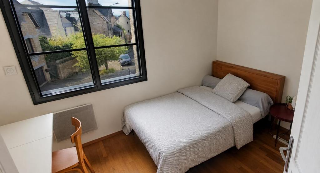 a small bedroom with a bed and a window at Near Train Station in Rennes