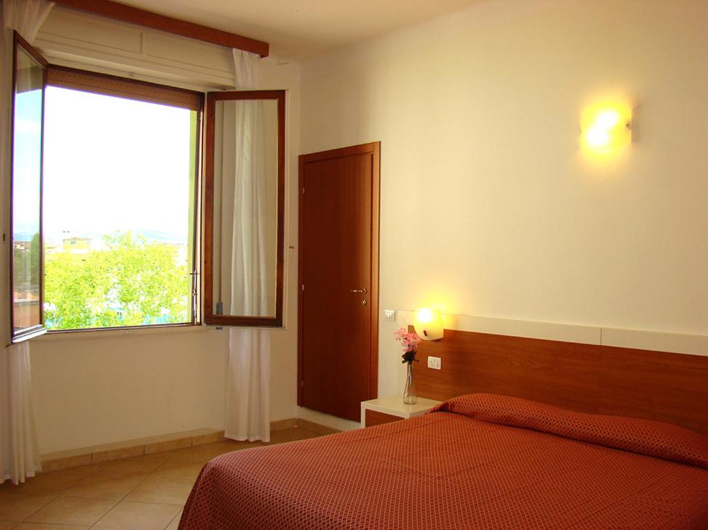 sypialnia z łóżkiem i dużym oknem w obiekcie B&B Soggiorno Ponte Rosso we Florencji