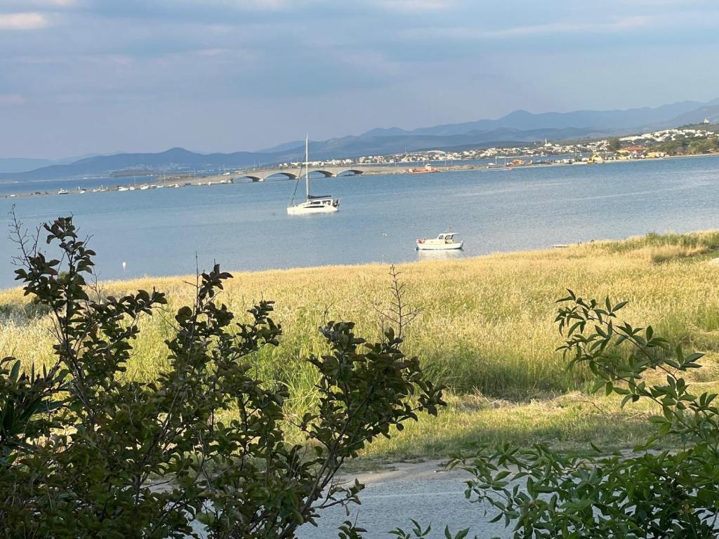 two boats in a large body of water with a bridge at Oran House in Ayvalık