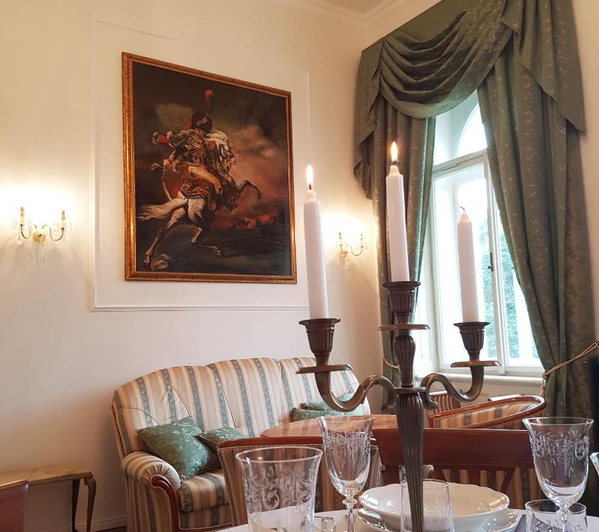 a living room with a couch and a painting on the wall at Charles apartment in Prague