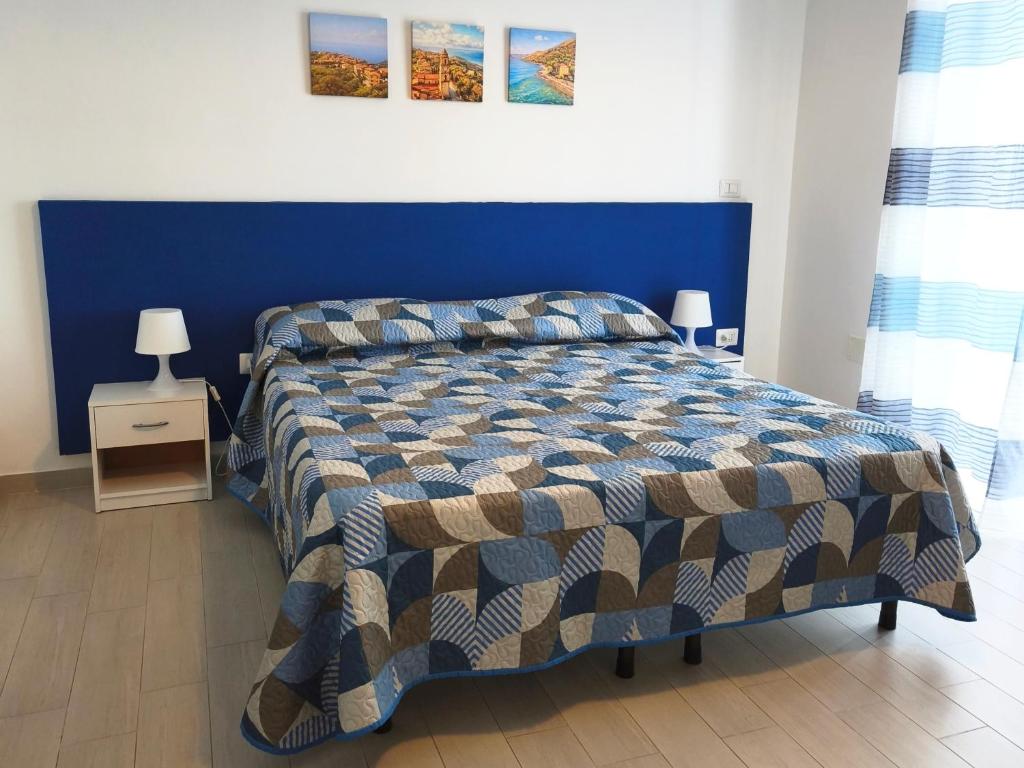 a bedroom with a bed with a blue wall at B&B Spirito Santo in Casal Sottano