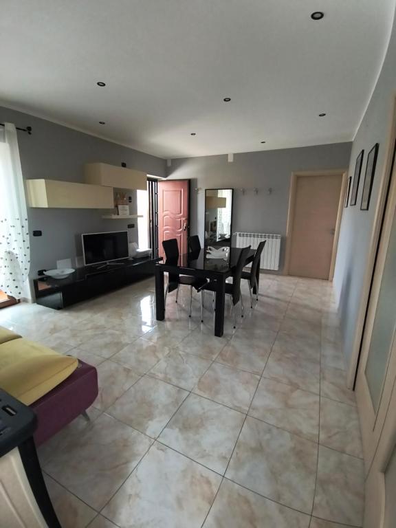 a large living room with a table and chairs at Dimora Melania in San Nicola Arcella
